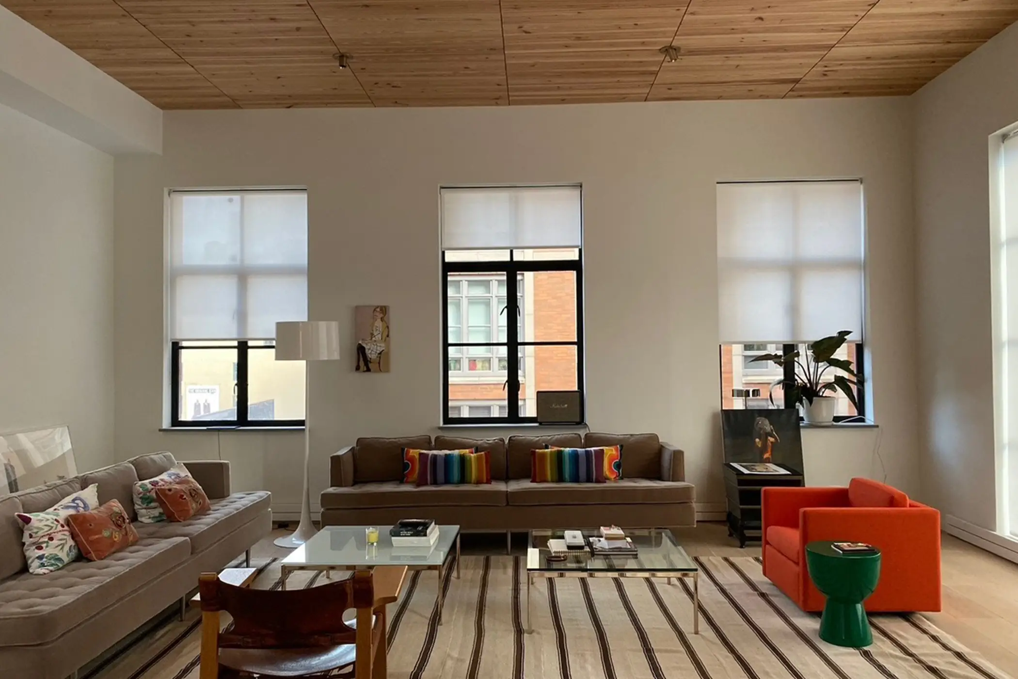 The Hamptons Retreat: linen Roman shades raised under a vaulted wood ceiling