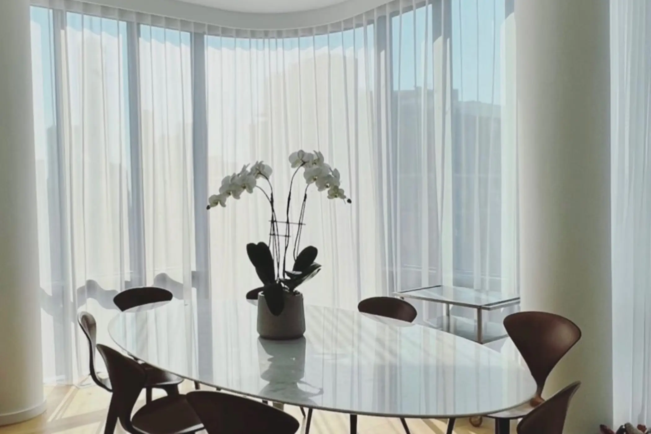 The Private Suite: bedroom with blue Roman shades raised against textured walls