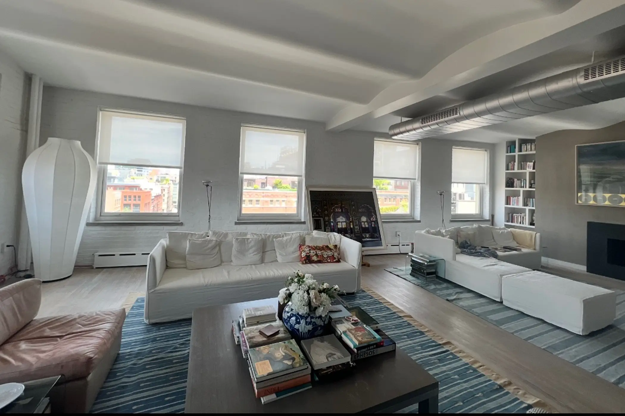 Tribeca Loft: living room with white motorized solar shades retracted